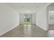 Empty living room with tiled floors and a sliding glass door with a view of the lawn at 4532 Windy Oak Way, St Cloud, FL 34772