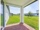 A covered patio with red brick flooring overlooks a green backyard at 4532 Windy Oak Way, St Cloud, FL 34772