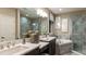 Luxurious bathroom featuring dual sinks, soaking tub, and separate marble-tiled shower at 4716 Coral Harbour Rd, Kissimmee, FL 34758