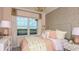 Bright bedroom with a large window, pink accents, stylish decor, and modern furnishings at 4716 Coral Harbour Rd, Kissimmee, FL 34758