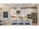 Modern kitchen with white cabinets, stainless steel appliances, and a large center island with seating at 4716 Coral Harbour Rd, Kissimmee, FL 34758