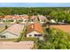 Aerial view of home featuring an orange tile roof, screened-in patio, and landscaped backyard at 618 Via Milano, Apopka, FL 32712