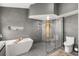Sleek modern bathroom featuring gray tile, floating tub, and glass enclosed shower at 618 Via Milano, Apopka, FL 32712