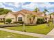 Beautiful single-story home has mature landscaping, a tile roof, and manicured lawn at 618 Via Milano, Apopka, FL 32712