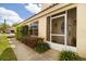 Charming home entrance with screened doorway, manicured landscaping, and walkway at 618 Via Milano, Apopka, FL 32712