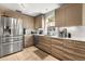Bright kitchen with tile flooring features stainless steel appliances and modern countertops at 618 Via Milano, Apopka, FL 32712