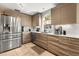 Bright kitchen with stainless steel appliances and tile flooring boasts modern countertops at 618 Via Milano, Apopka, FL 32712