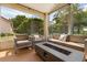Screened lanai with comfortable outdoor seating around a modern gas fire pit at 618 Via Milano, Apopka, FL 32712