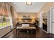 Bright main bedroom features dark hardwood floors, bench seating, and warm ambient lighting at 618 Via Milano, Apopka, FL 32712