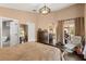 Spacious main bedroom features dark wood floors, an elegant light fixture, and access to the screened lanai at 618 Via Milano, Apopka, FL 32712