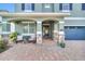 Inviting front porch with stone accents, seating area, and a beautiful entryway door at 7503 Marker Ave, Kissimmee, FL 34747