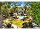 Aerial view of a stunning estate featuring lush landscaping, a pool, and multiple outbuildings at 7849 Georgeann St, Winter Park, FL 32792
