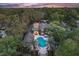 Stunning aerial view of a luxury home with a large pool, spa, and lush tropical landscaping at 7849 Georgeann St, Winter Park, FL 32792
