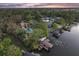 Gorgeous waterfront estate featuring a private dock and boat lift, surrounded by lush landscaping at 7849 Georgeann St, Winter Park, FL 32792