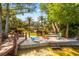 Tranquil backyard featuring a sandy beach area, private dock, and lush landscaping at 7849 Georgeann St, Winter Park, FL 32792