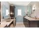 Well-lit bathroom featuring tile accents, a stylish vanity, and a comfortable makeup station at 7849 Georgeann St, Winter Park, FL 32792