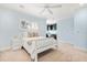 Bedroom with white trim, shutters and a light blue wall, as well as a small desk in the corner of the room at 7849 Georgeann St, Winter Park, FL 32792