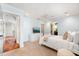 Bright bedroom with a ceiling fan, white furnishings, and an en-suite bathroom entrance at 7849 Georgeann St, Winter Park, FL 32792