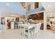 Open-concept dining area with white table, chairs, and clear view of the modern kitchen at 7849 Georgeann St, Winter Park, FL 32792
