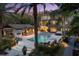 Nighttime view of an estate home with a pool, spa, and outdoor living spaces at 7849 Georgeann St, Winter Park, FL 32792