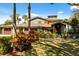 Beautiful home with lush landscaping, mature trees, and a well-manicured lawn at 7849 Georgeann St, Winter Park, FL 32792