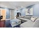Comfortable living room featuring a large sectional sofa, arcade game, and modern decor at 7849 Georgeann St, Winter Park, FL 32792