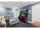 Cozy living room with blue walls, a modern ceiling fan, and a plush sectional sofa at 7849 Georgeann St, Winter Park, FL 32792