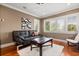 Comfortable living room featuring hardwood floors, white plantation shutters, and stylish decor at 7849 Georgeann St, Winter Park, FL 32792