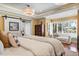 Bright main bedroom with plenty of natural light from the windows and a stylish sliding door to ensuite bathroom at 7849 Georgeann St, Winter Park, FL 32792