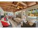 Inviting outdoor living space with beamed ceilings, bar, lounge seating, and views of the pool at 7849 Georgeann St, Winter Park, FL 32792