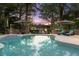 Beautiful pool reflecting a scenic view of the lake and lush landscaping at twilight at 7849 Georgeann St, Winter Park, FL 32792