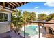 Beautiful backyard oasis with a pool, lush landscaping, and serene lake views at 7849 Georgeann St, Winter Park, FL 32792