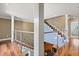 Bright staircase with hardwood steps, modern steel railing, and freshly painted walls and trim at 7849 Georgeann St, Winter Park, FL 32792