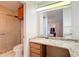 Bathroom features a granite counter, shower, and vanity with wood drawers and cabinets at 840 Cortez Ave, The Villages, FL 32159