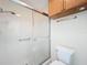 Clean bathroom features shower, commode, and a vanity with storage cabinets overhead at 840 Cortez Ave, The Villages, FL 32159