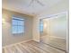 Well-lit, empty bedroom features wood floors, and a large mirrored closet for storage at 840 Cortez Ave, The Villages, FL 32159