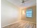 Spacious bedroom features wood floors, window, and sconce-style lighting at 840 Cortez Ave, The Villages, FL 32159