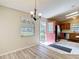 Cozy dining room with view of the kitchen featuring wood cabinets and stainless steel appliances at 840 Cortez Ave, The Villages, FL 32159