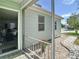Inviting patio area with decorative stone and a view of the well maintained home exterior at 840 Cortez Ave, The Villages, FL 32159