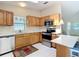 Well-lit kitchen with wooden cabinets, stainless steel appliances, and white countertops at 840 Cortez Ave, The Villages, FL 32159