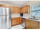 Well-equipped kitchen with wooden cabinets, stainless steel appliances, and white countertops at 840 Cortez Ave, The Villages, FL 32159