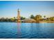 Scenic lakefront view featuring charming lakeside dining and an iconic water tower at 840 Cortez Ave, The Villages, FL 32159