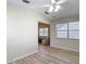 Open-concept living space with wood-look floors flowing into a sunroom, perfect for relaxed living and entertaining at 840 Cortez Ave, The Villages, FL 32159