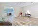 Spacious living room with wood-look floors leading to a sunroom, offering a seamless transition and a comfortable living area at 840 Cortez Ave, The Villages, FL 32159