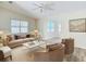Bright living room featuring a plush sofa, marble coffee table, and comfortable seating, creating an inviting atmosphere at 840 Cortez Ave, The Villages, FL 32159