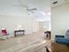 Bright living room with wood-look floors connecting to the kitchen, creating an open and airy living space at 840 Cortez Ave, The Villages, FL 32159