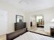 Comfortable main bedroom features a ceiling fan, wood floors, dresser and mirrored closet at 840 Cortez Ave, The Villages, FL 32159