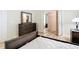Comfortable bedroom features a dresser, wood floors, and a mirrored closet for ample storage at 840 Cortez Ave, The Villages, FL 32159