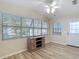 Bright sunroom with many windows, wood-look flooring, and a door leading to the outside, a cozy and inviting space at 840 Cortez Ave, The Villages, FL 32159