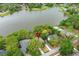 Aerial view of a lakefront home surrounded by trees, offering a private and serene setting at 858 Lake Marion Dr, Altamonte Springs, FL 32701